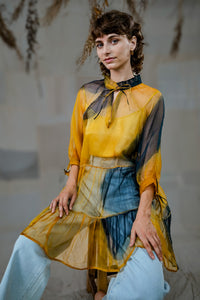Woman wearing HeenaAgrima's Sunny Silk Organza Long Top, a yellow and blue layered outfit against a neutral background