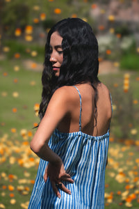 Woman in a blue tiered dress standing outdoors with blurred background - HeenaAgrima
