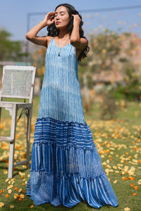 Woman in a blue tiered dress standing outdoors with blurred background - HeenaAgrima