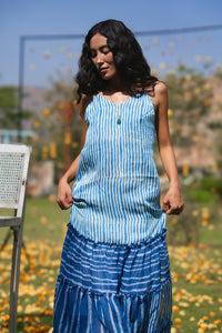 Woman in a blue tiered dress standing outdoors with blurred background - HeenaAgrima