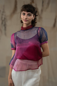 Woman wearing HeenaAgrima's Amethyst Silk Organza Top, a sheer, multicolored top with a blurred natural background