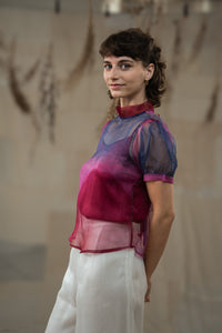 Woman wearing HeenaAgrima's Amethyst Silk Organza Top, a sheer, multicolored top with a blurred natural background