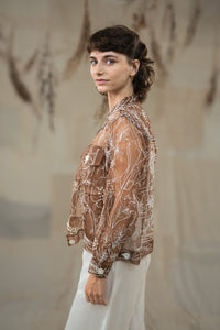 Woman wearing HeenaAgrima's Jaisalmer Jacket, a brown floral jacket against a neutral background