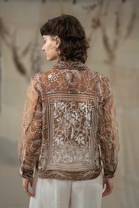 Woman wearing HeenaAgrima's Jaisalmer Jacket, a brown floral jacket against a neutral background.