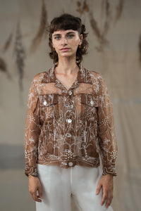 Woman wearing HeenaAgrima's Jaisalmer Jacket, a brown floral jacket against a neutral background. 