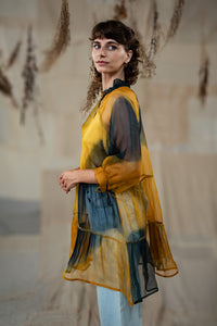 Woman wearing HeenaAgrima's Sunny Silk Organza Long Top, a yellow and blue layered outfit against a neutral background