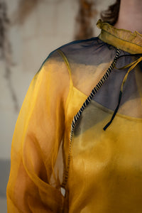 Woman wearing HeenaAgrima's Sunny Silk Organza Long Top, a yellow and blue layered outfit against a neutral background