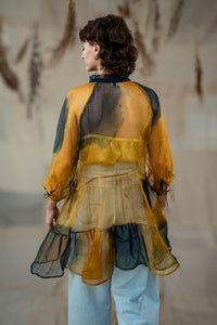 Woman wearing HeenaAgrima's Sunny Silk Organza Long Top, a yellow and blue layered outfit against a neutral background