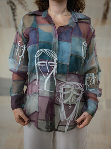 Woman wearing Stormy 2.0 patchwork shirt a colorful, patterned shirt with a neutral background