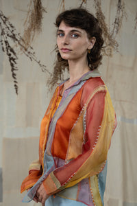 Woman wearing HeenaAgrima's Verti 2.0 Silk Organza Shirt, a colorful, patterned shirt with a neutral background
