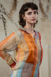 Woman wearing HeenaAgrima's Verti 2.0 Silk Organza Shirt, a colorful, patterned shirt with a neutral background