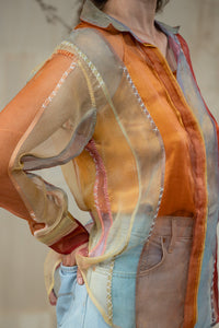 Woman wearing HeenaAgrima's Verti 2.0 Silk Organza Shirt, a colorful, patterned shirt with a neutral background