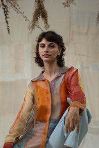 Woman wearing HeenaAgrima's Verti 2.0 Silk Organza Shirt, a colorful, patterned shirt with a neutral background