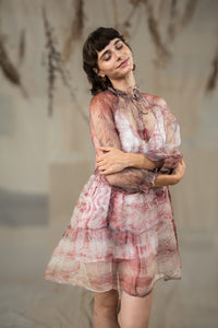 Woman wearing HeenaAgrima's black current organza dress, a patterned dress standing against a neutral background