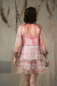 Woman wearing HeenaAgrima's black current organza dress, a sheer, layered dress with a blurred background