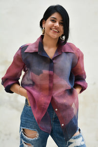 Woman wearing a colorful silk shirt with a blurred background