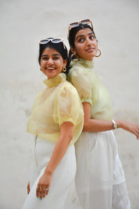 Two women wearing light yellow tops and white pants against a plain background - OG Fallon Organza Shirt by HeenaAgrima