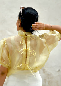 Girl wearing a yellow Organza Shirt with sheer sleeves and white pants against a light background - OG fallon Organza Shirt by HeenaAgrima