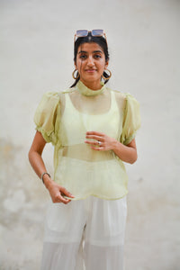 Woman wearing a light green Organza Shirt with sheer sleeves against a neutral background - OG Fallon Organza Shirt by HeenaAgrima
