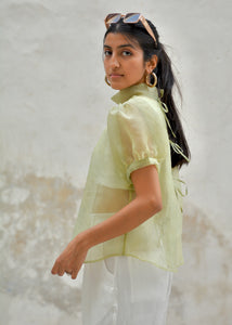 Woman wearing a light green blouse with white pants against a textured wall - OG Fallon Organza Shirt - HeenaAgrima