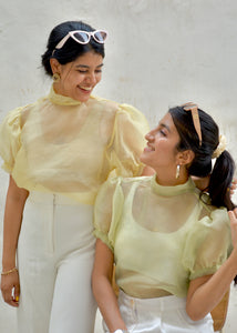 Two women wearing sheer organza yellow tops and white pants against a plain background - OG Fallon Organza Shirt by HeenaAgrima