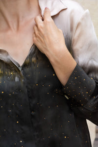 Close-up of a Woman wearing HenaAgrima's Papilio Satin Silk Shirt, a black and gray gradient outfit against a neutral background