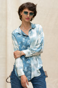 Woman wearing HeenaAgrima's Blu Shibo Shirt, a blue and white patterned shirt with sunglasses and hoop earrings.