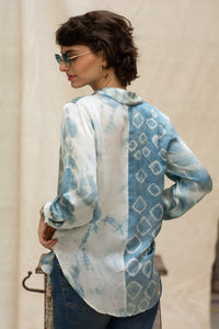 Woman wearing HeenaAgrima's Blu Shibo Shirt, a blue and white patterned shirt with sunglasses and hoop earrings.