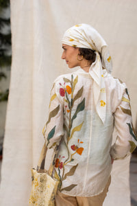 Woman wearing a floral shirt, Garden Shirt by  HeenaAgrima with a blurred outdoor background