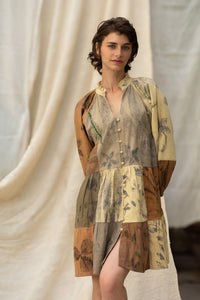Woman wearing HeenaAgrima's Venus Handloom Cotton Dress patchwork dress with a floral pattern against a draped fabric background