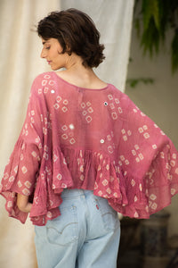Woman wearing a pink patterned cotton blouse, named love bug top made by HeenaAgrima. 