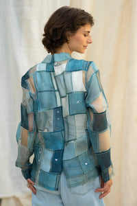 Woman wearing HeenaAgrima's Blu Dream Jacket, a blue patchwork organza jacket against a neutral, blurred background. 