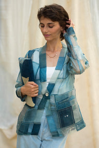 Woman wearing HeenaAgrima's Blu Dream Jacket, a blue patchwork organza jacket against a neutral blurred background. 