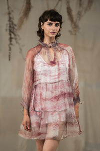 Woman wearing HeenaAgrima's black current organza dress, a sheer, patterned dress against a neutral background.