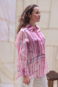 Woman wearing HeenaAgrima's Candy Cane Organza Shirt, a pink striped shirt with a blurred background
