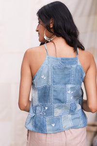Woman wearing HeenaAgrima's taylor tank top with a plain background