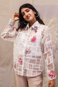 Woman wearing heenaAgrima Snow Blossom Organza Shirt, a white sheer shirt with floral embroidery against a neutral background
