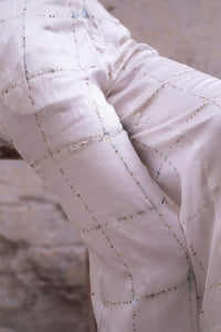 Close-up of a quilt with a diamond pattern on a textured surface