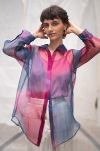 Woman wearing HeenaAgrima's Oasis 2.0 Silk Organza Shirt, a colorful, sheer shirt, naturally dyed sappanwood and indigo. 