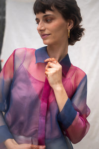 Woman wearing HeenaAgrima's Oasis 2.0 Silk Organza Shirt, a colorful, sheer shirt, naturally dyed sappanwood and indigo. 