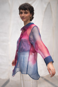 Woman wearing HeenaAgrima's Oasis 2.0 Silk Organza Shirt, a colorful, sheer shirt, naturally dyed sappanwood and indigo. 