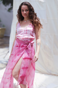 Woman wearing HeenaAgrima's Gulabi Skirt, a pink tie-dye dress with a white background