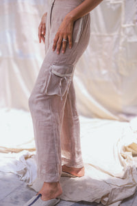 HeenaAgrima's Accord Linen Pants, Light-colored pants worn by a person on a soft, neutral background
