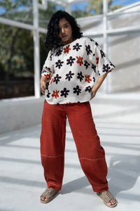 Woman in madder red naturally dyed handloom cotton pants, comfortable for daily wear.