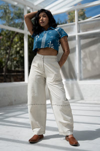 Woman wearing white handloom cotton pants, naturally dyed, suitable for daily wear.